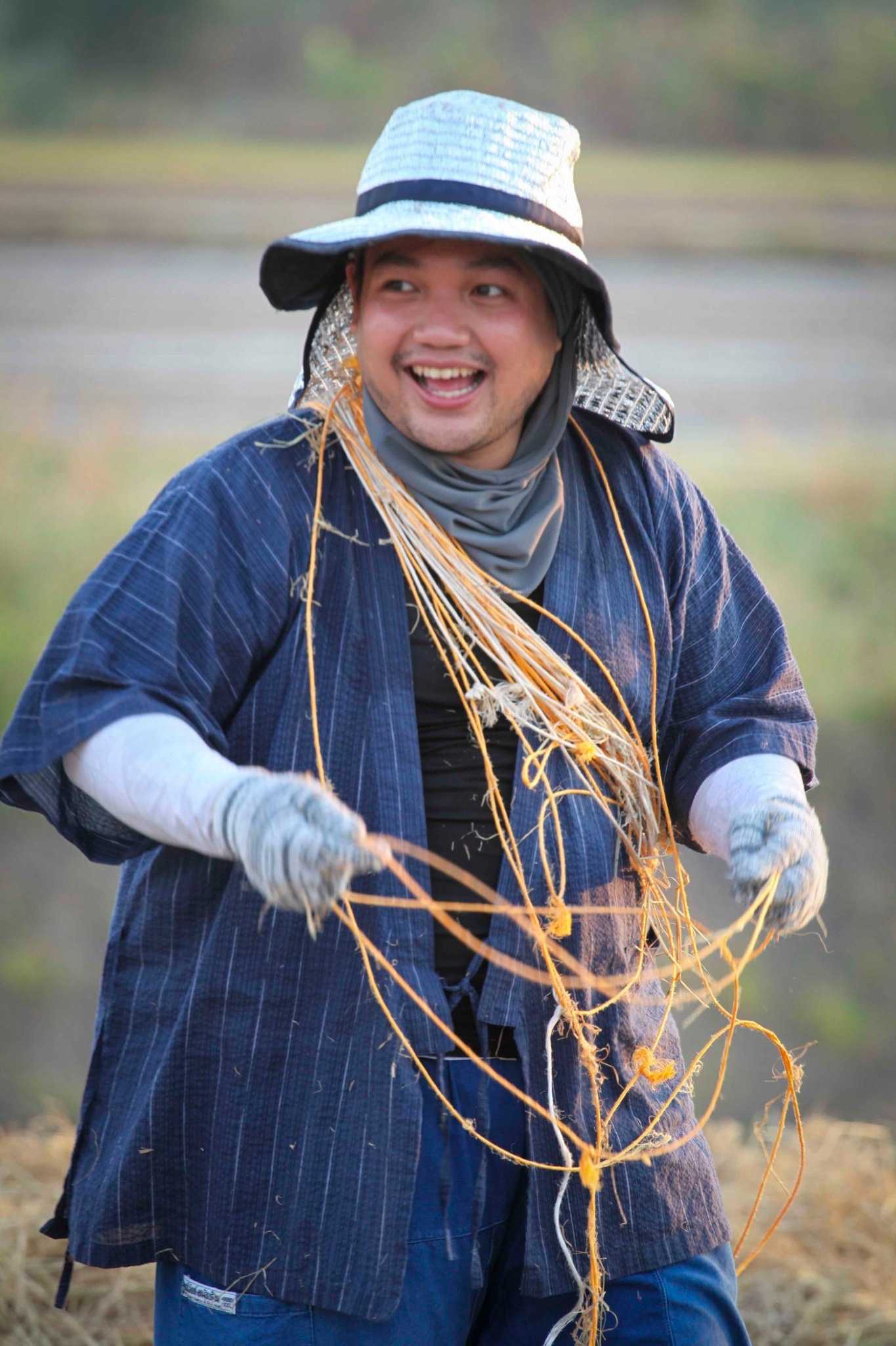 Person working with rice straw